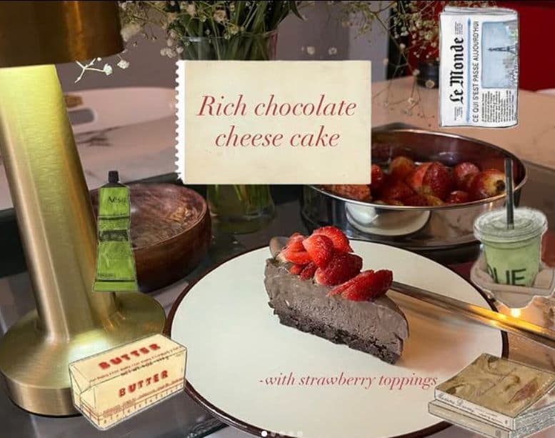 A rich chocolate cheesecake with strawberry topping on a cake stand.